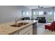 Modern kitchen with granite countertops and a view into the living space at 47737 W Coe St, Maricopa, AZ 85139