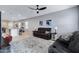 Open-concept living space with a view into the kitchen, featuring neutral decor and a comfortable seating area at 47737 W Coe St, Maricopa, AZ 85139