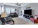 Comfortable living room featuring neutral colors, recessed lighting, a modern ceiling fan, and stylish furnishings at 47737 W Coe St, Maricopa, AZ 85139