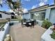 A backyard with a patio including an outdoor dining area with neutral-toned concrete landscaping at 5146 W Echo Ln, Glendale, AZ 85302