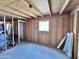 Unfinished basement showcasing exposed framing, plywood, and a window for natural light, awaiting personalization at 5146 W Echo Ln, Glendale, AZ 85302