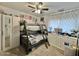 Cozy bedroom showcasing a bunk bed with a fan overhead, complemented by a dresser, curtains, and neutral carpet at 5146 W Echo Ln, Glendale, AZ 85302