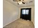 This bedroom boasts dark curtains, plush carpet, ceiling fan, and neutral walls providing a comforting and subdued feel at 5146 W Echo Ln, Glendale, AZ 85302