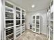 Walk-in closet with glass-fronted shelving and drawers, providing ample storage space at 5146 W Echo Ln, Glendale, AZ 85302