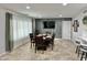 Well-lit dining area featuring modern decor and lots of seating adjacent to the kitchen at 5146 W Echo Ln, Glendale, AZ 85302