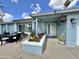 Close up of the home featuring a cozy seating area, colorful flower beds, and a well-manicured lawn at 5146 W Echo Ln, Glendale, AZ 85302