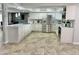 Bright kitchen featuring white cabinets, stainless steel appliances, and a spacious marble-topped island at 5146 W Echo Ln, Glendale, AZ 85302