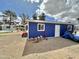 Exterior view of the backyard outbuilding featuring blue siding, a window, door, and a desert landscape at 5146 W Echo Ln, Glendale, AZ 85302