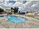 Outdoor pool area with a diving board, a seating area under pergola, and a serene backyard setting at 5146 W Echo Ln, Glendale, AZ 85302