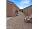 The side of the house features a gravel-covered area with a chair and pool equipment at 528 E Wolf Hollow Dr, Casa Grande, AZ 85122