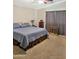 Bedroom with neutral carpet, a comfortable bed, and dark curtains at 528 E Wolf Hollow Dr, Casa Grande, AZ 85122