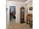 Foyer with tile flooring, grandfather clock and vintage desk at 528 E Wolf Hollow Dr, Casa Grande, AZ 85122