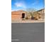 Inviting single-story home featuring desert landscaping, a two-car garage, and neutral exterior at 528 E Wolf Hollow Dr, Casa Grande, AZ 85122