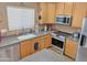 Well-equipped kitchen featuring light wood cabinetry, stainless steel appliances, and functional layout at 528 E Wolf Hollow Dr, Casa Grande, AZ 85122