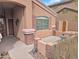 Cozy front patio with brick accents, a small seating area, and desert landscaping at 528 E Wolf Hollow Dr, Casa Grande, AZ 85122