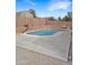 Backyard pool with a basketball hoop, surrounded by a brick wall for privacy at 528 E Wolf Hollow Dr, Casa Grande, AZ 85122