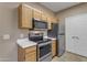 Kitchen featuring stainless steel appliances, light wood cabinets, and white countertops at 5401 E Van Buren St # 1103, Phoenix, AZ 85008