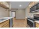 Kitchen featuring stainless steel appliances, light wood cabinets, and light countertops with a tile floor at 5401 E Van Buren St # 1103, Phoenix, AZ 85008