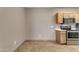 Kitchen featuring stainless steel appliances, light wood cabinets, light countertops and tile floors at 5401 E Van Buren St # 1103, Phoenix, AZ 85008