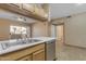 Kitchen featuring stainless steel appliances, light wood cabinets, white countertops and a dual sink at 5401 E Van Buren St # 1103, Phoenix, AZ 85008