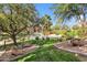 Beautiful water feature with fountains, lush landscaping, mature trees, and apartment buildings in the background at 5401 E Van Buren St # 1103, Phoenix, AZ 85008