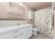 Well-maintained bathroom featuring a clean white vanity, decorative tile and shower with curtain at 5401 E Van Buren St # 2053, Phoenix, AZ 85008