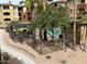 Charming courtyard with trees, flower beds, and a fence, creating a private and serene outdoor space at 5401 E Van Buren St # 2053, Phoenix, AZ 85008