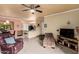 Cozy living room featuring neutral walls, a ceiling fan, comfortable seating, and an open layout to the kitchen at 5401 E Van Buren St # 2053, Phoenix, AZ 85008