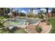 Expansive pond with fountains, surrounded by manicured landscaping and buildings under sunny skies at 5401 E Van Buren St # 2053, Phoenix, AZ 85008