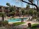 Inviting community pool with comfortable lounge chairs and manicured landscaping under sunny skies at 5401 E Van Buren St # 2053, Phoenix, AZ 85008