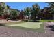 Putting green surrounded by manicured lawns and trees at this condominium complex at 5401 E Van Buren St # 2053, Phoenix, AZ 85008