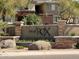 Red Rox Condominium Residences sign surrounded by desert landscaping and stone accents at 5401 E Van Buren St # 2053, Phoenix, AZ 85008