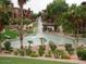 Picturesque water feature surrounded by lush landscaping, palm trees, and apartment buildings in the background at 5401 E Van Buren St # 2053, Phoenix, AZ 85008