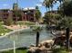 Calming water feature with palm trees and lush landscaping at this condominium complex at 5401 E Van Buren St # 2053, Phoenix, AZ 85008