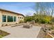 Backyard features desert landscaping, a built-in fire pit with seating area, and a view of the home's exterior at 5411 E Duane Ln, Cave Creek, AZ 85331