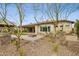 Home's backyard with desert landscaping, a fire pit, and an outdoor kitchen area at 5411 E Duane Ln, Cave Creek, AZ 85331