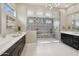 Contemporary bathroom featuring a large glass shower, dual vanities and herringbone tile at 5411 E Duane Ln, Cave Creek, AZ 85331