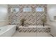 Luxurious bathroom featuring a soaking tub, glass-enclosed shower, and stylish herringbone tile design at 5411 E Duane Ln, Cave Creek, AZ 85331