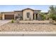 Charming home with a tidy front yard showcasing rock landscaping, desert plants, and a two-car garage at 5411 E Duane Ln, Cave Creek, AZ 85331