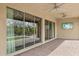 Covered outdoor patio featuring tiled flooring, a ceiling fan, and sliding glass doors to the home's interior at 5411 E Duane Ln, Cave Creek, AZ 85331