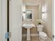 Elegant powder room featuring a pedestal sink, decorative lighting, and stylish fixtures at 5411 E Duane Ln, Cave Creek, AZ 85331