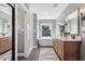 Elegant bathroom with a soaking tub, marble shower, dual vanities, and modern fixtures at 5529 N 19Th St, Phoenix, AZ 85016