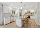 Bright, modern kitchen with white cabinets, granite countertops, stainless steel appliances, and a center island with seating at 5529 N 19Th St, Phoenix, AZ 85016