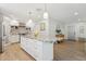 Contemporary kitchen featuring a large island, stainless steel appliances, white cabinetry, and stylish pendant lighting at 5529 N 19Th St, Phoenix, AZ 85016