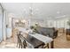 Open-concept living area with a modern chandelier, seamless flow to the kitchen, and stylish furnishings at 5529 N 19Th St, Phoenix, AZ 85016