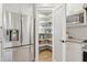 Well-organized pantry with white shelves and modern appliances adjacent to the kitchen area at 5529 N 19Th St, Phoenix, AZ 85016