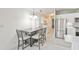 Dining area adjacent to the kitchen features a table with seating for four and view to laundry at 5735 E Mcdowell Rd # 197, Mesa, AZ 85215