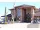 Striking brick exterior featuring desert landscaping, covered entry, and American flag waving proudly at 5735 E Mcdowell Rd # 197, Mesa, AZ 85215