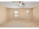 Sun-filled bedroom features a ceiling fan and three large sunny windows at 5828 E Hoover Ave, Mesa, AZ 85206