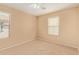 Bedroom features carpet, neutral colored walls, a ceiling fan and two large windows at 5828 E Hoover Ave, Mesa, AZ 85206